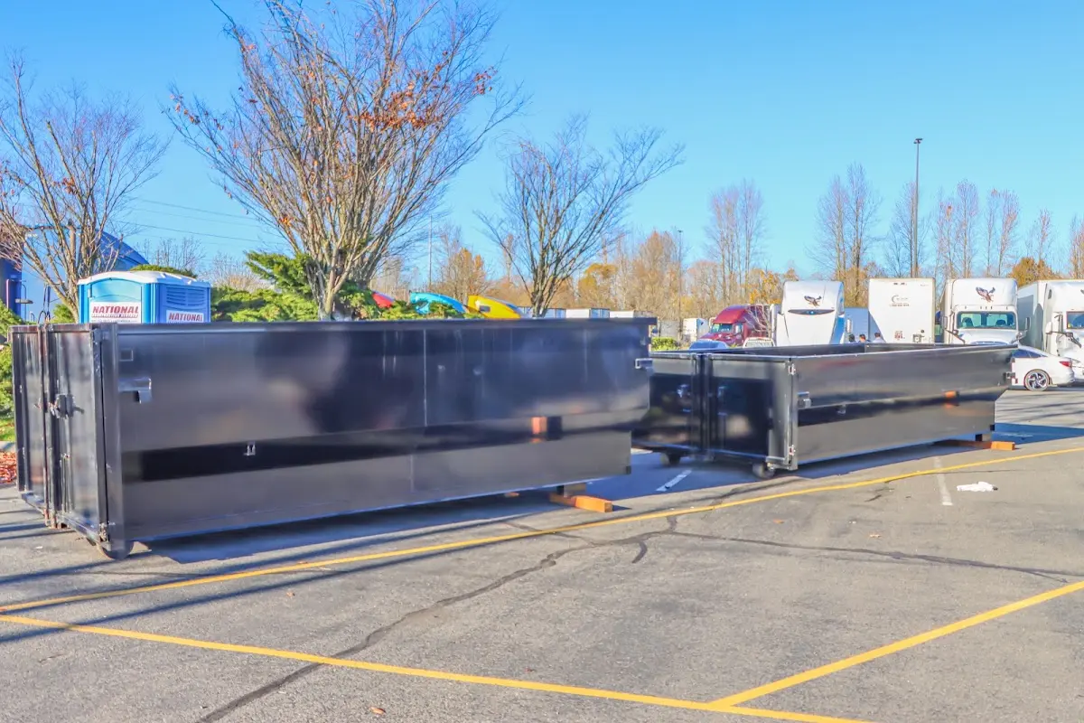 Professional dumpster rental service with roll-off container on residential driveway in Page